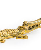 A small metallic gold alligator figurine with a textured scale pattern, shown on a plain white background.