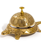 Gold turtle-shaped bell on a white background