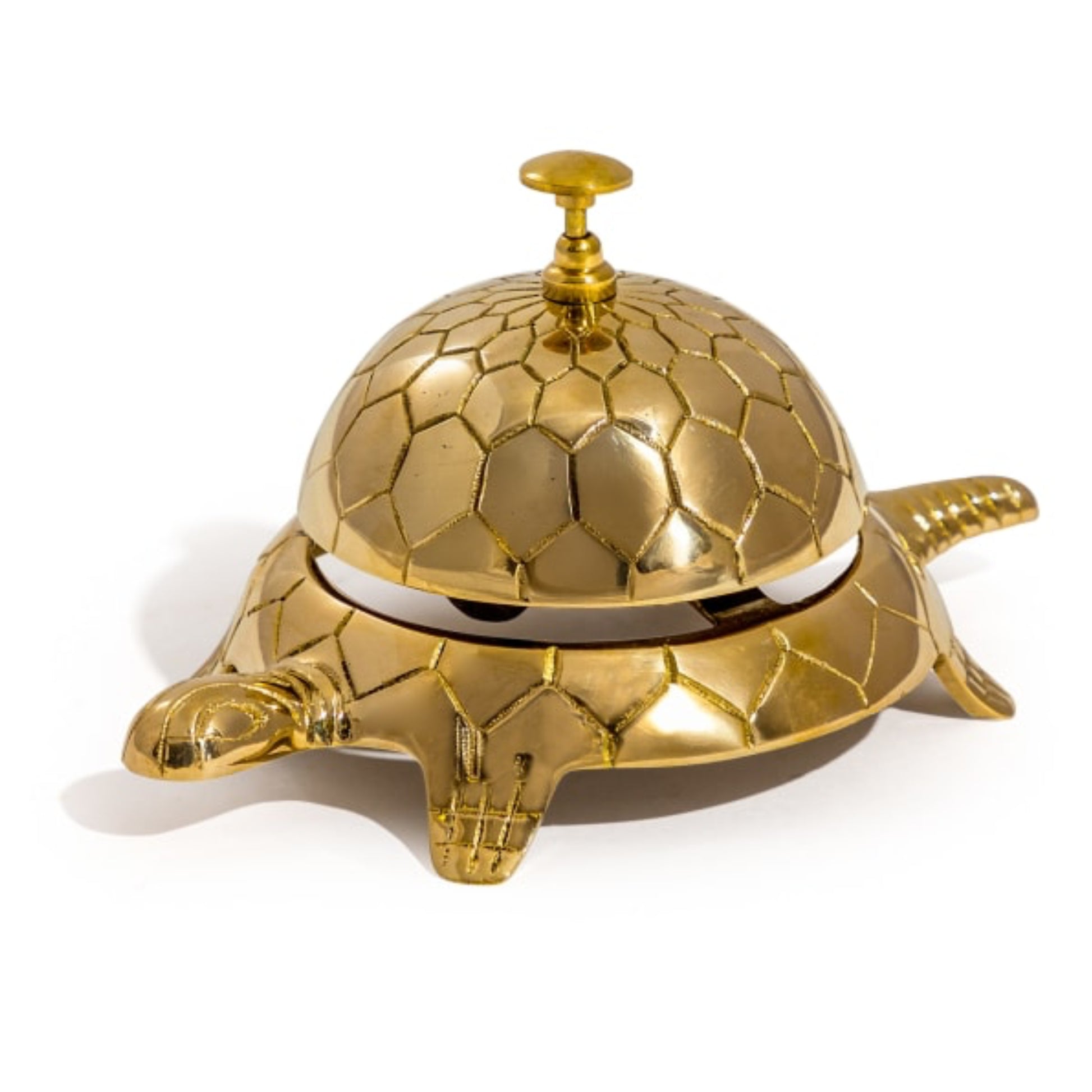 Gold turtle-shaped bell on a white background