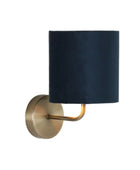 Wall sconce with black shade and gold fixture on a white background