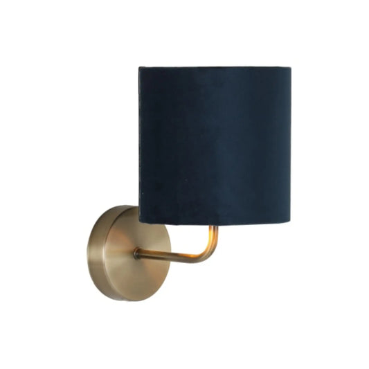 Wall sconce with black shade and gold fixture on a white background