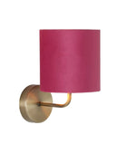 Wall sconce with a pink lampshade and gold fixture on a white background