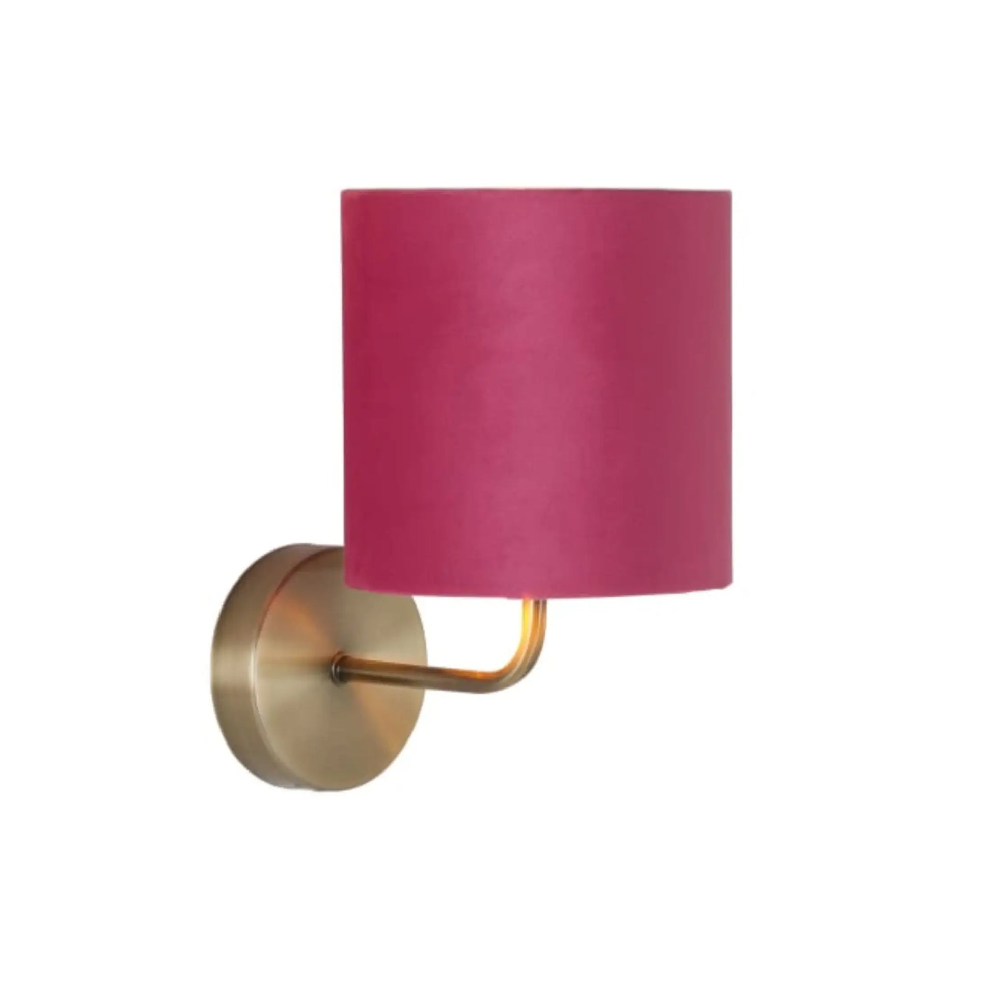 Wall sconce with a pink lampshade and gold fixture on a white background