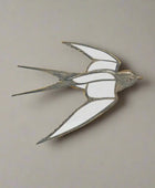 Decorative metal swallow sculpture on a white background