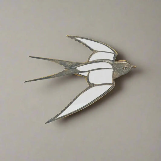 Decorative metal swallow sculpture on a white background
