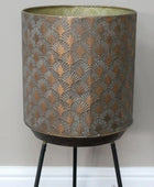 Decorative lamp with patterned shade and black legs on a white background