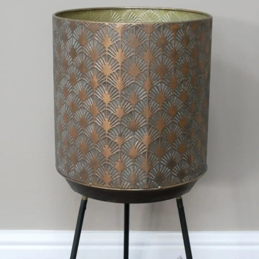 Decorative lamp with patterned shade and black legs on a white background