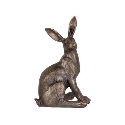 Bronze rabbit statue on a white background