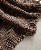 Brown textured blanket on a light gray surface