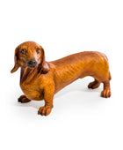 Brown dachshund figurine on a white background