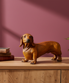 Dog figurine on a wooden surface with books and a plant against a maroon wall