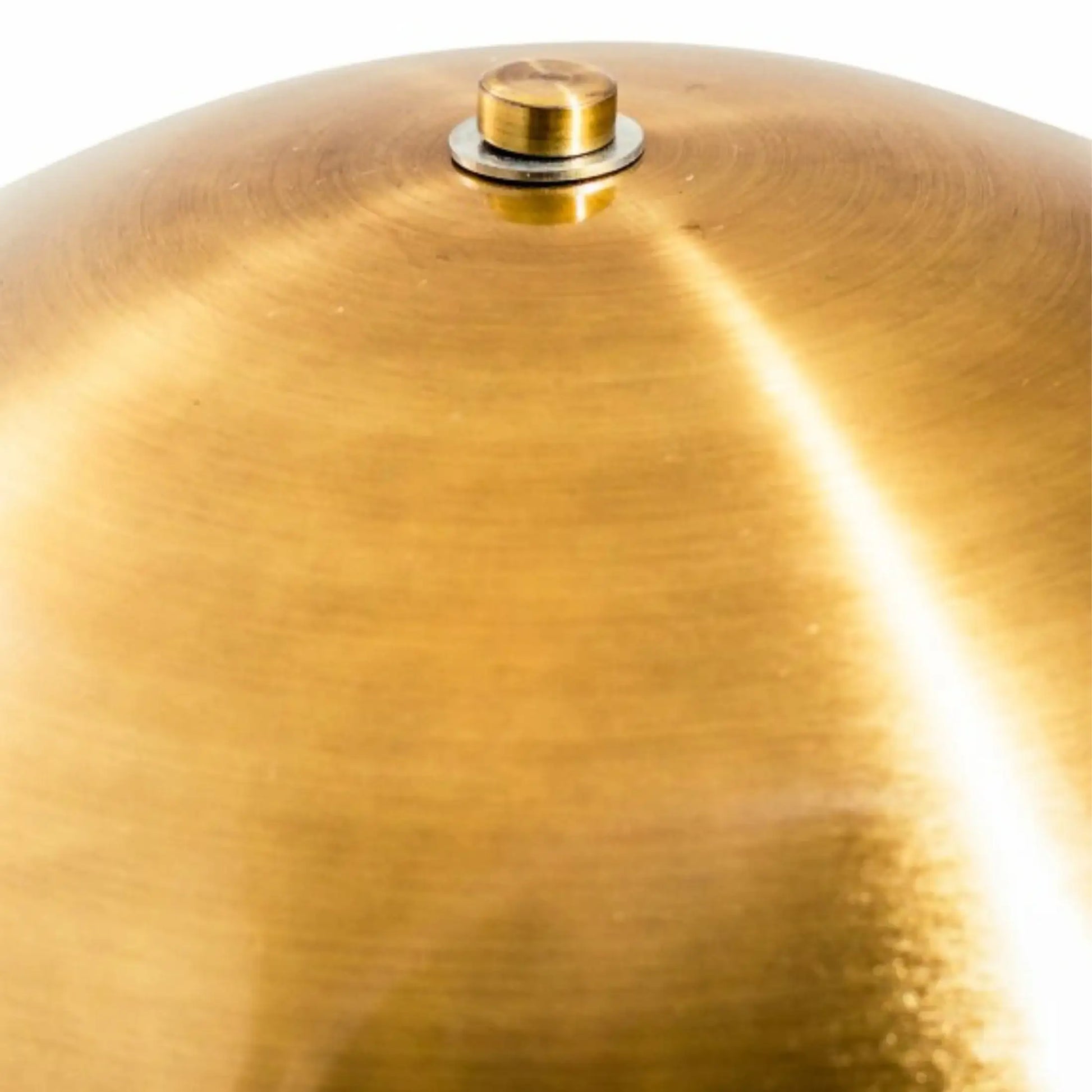 Close-up of a gold cymbal with a reflective surface