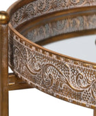 Decorative round table with intricate gold patterns on a white background