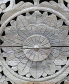 Close-up of a wooden carvings with floral patterns on a black background