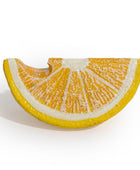 A decorative ceramic wall vessel shaped like a lemon slice, featuring textured yellow-orange rind and white pith details, set against a plain white background.