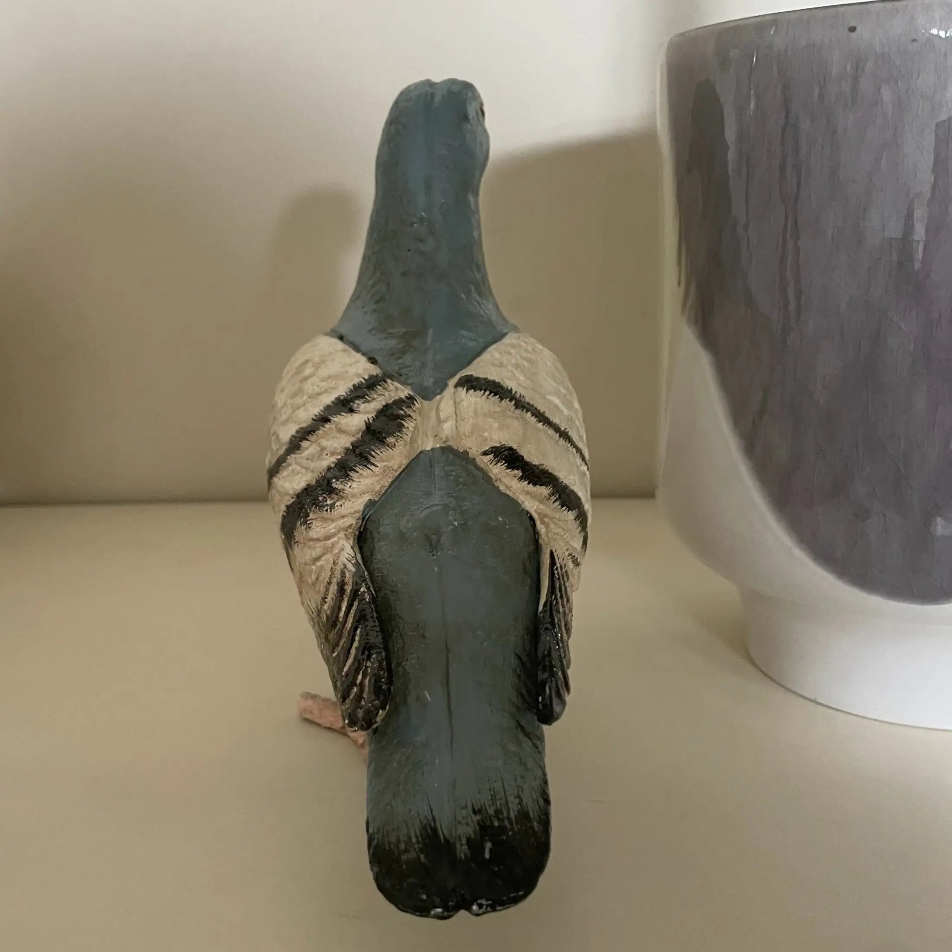 Decorative goose figure with a textured surface on a plain background