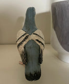 Decorative goose figure with a textured surface on a plain background