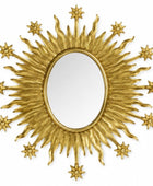 Decorative gold sunburst mirror with star accents on a white background