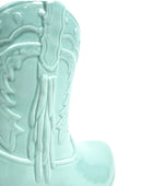 Light blue ceramic boot with horse design on a white background