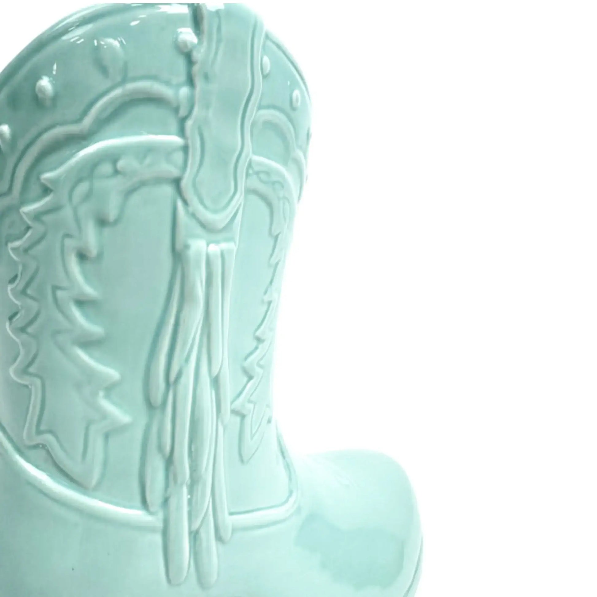 Light blue ceramic boot with horse design on a white background