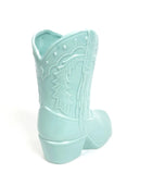 Light blue cowboy boot-shaped container on a white background