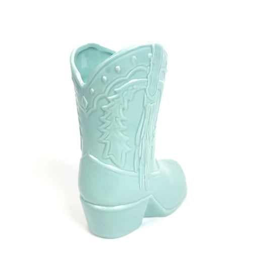 Light blue cowboy boot-shaped container on a white background