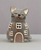 Ceramic cat-shaped house figurine on a white background