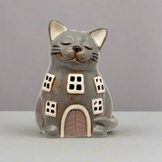 Ceramic cat-shaped house figurine on a white background
