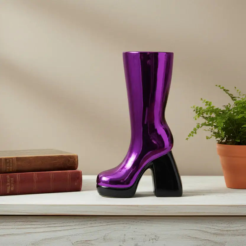 Shiny purple boot on a shelf with books and a plant