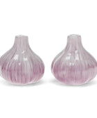 Two garlic-shaped salt and pepper shakers with a glossy, ribbed texture in a light purple and white color scheme, set against a plain white background.