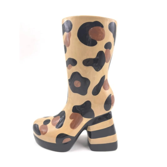 Tan boot with black and brown abstract pattern on a white background