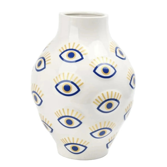 White vase with blue and yellow eye pattern on a white background