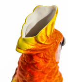 Close-up of a ceramic parrot with a yellow beak on a white background
