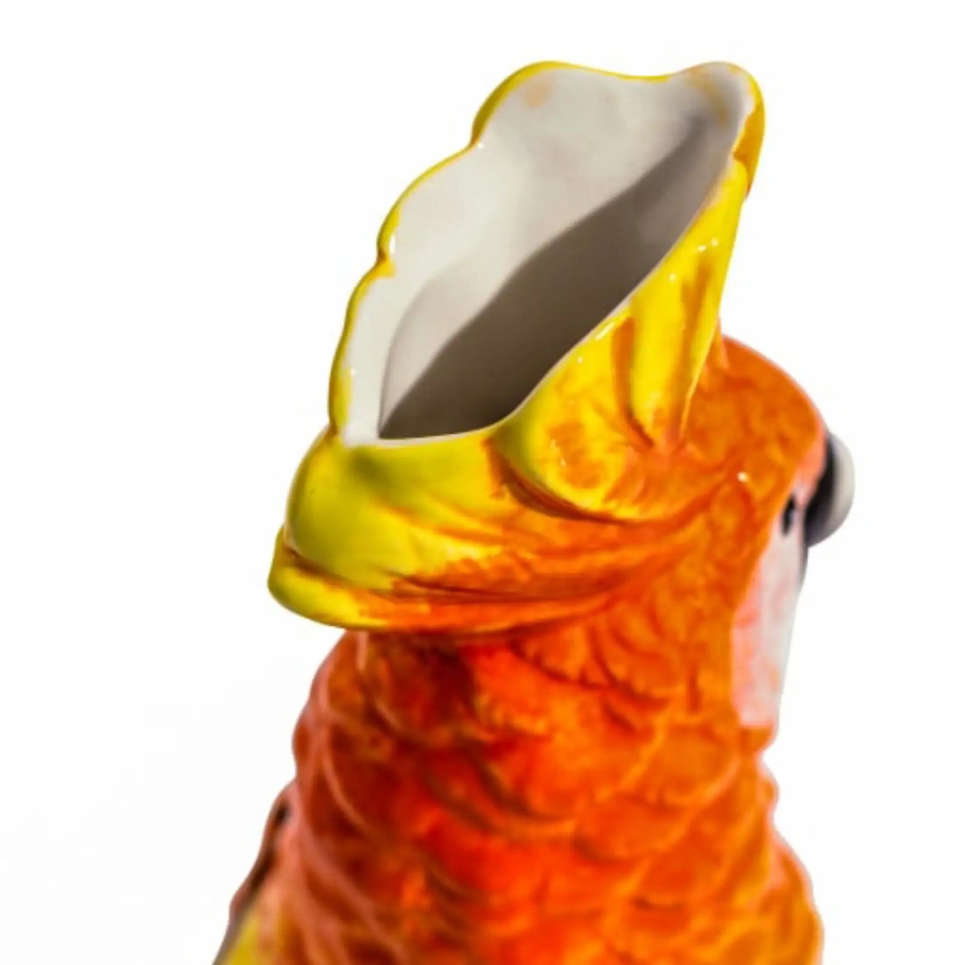 Close-up of a ceramic parrot with a yellow beak on a white background