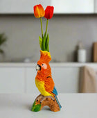 Colorful parrot figurine with tulips on a white background