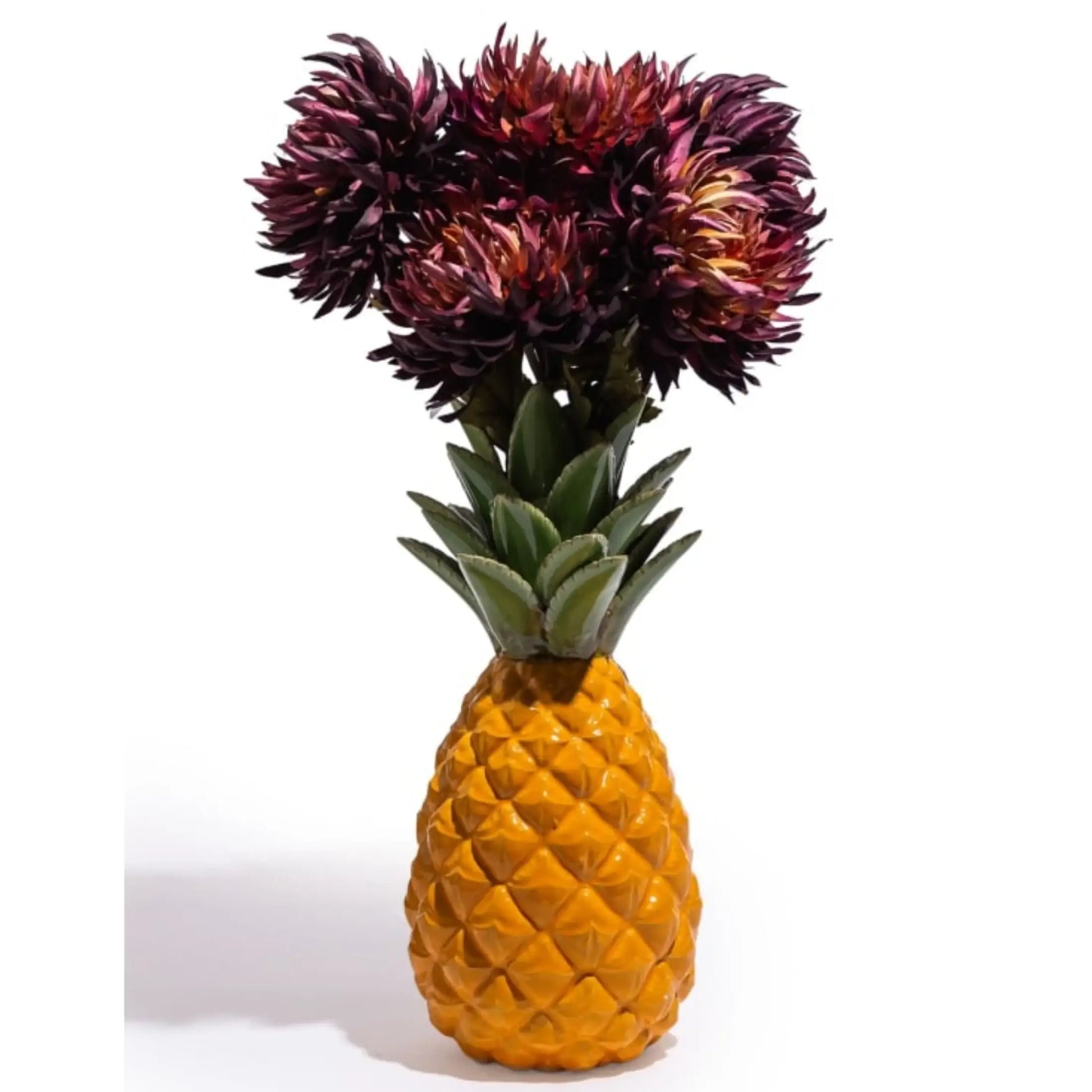 Pineapple-shaped vase with dark purple flowers on a white background