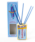 A Sardinian ampfrey reed diffuser set with a yellow and blue decorative holder, three blue reeds, and its matching blue retail box on a white background.