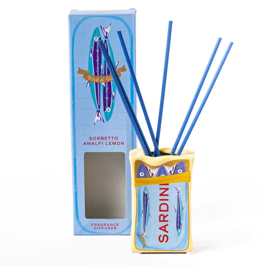A Sardinian ampfrey reed diffuser set with a yellow and blue decorative holder, three blue reeds, and its matching blue retail box on a white background.