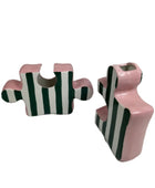 Pair of pink and black striped earrings on a white background