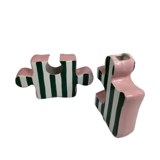 Pair of pink and black striped earrings on a white background