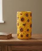Decorative vase with sunflower pattern on a wooden surface