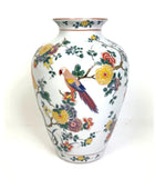 Decorative vase with floral and parrot design on a white background