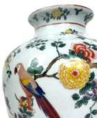 Decorative vase with floral and parrot design on a white background