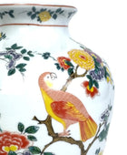 Decorative vase with colorful parrot and floral design on a white background