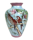 Decorative vase with parrot design on a light blue background
