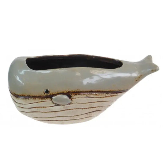A ceramic whale-shaped planter with a glossy light gray-blue upper body, a textured cream lower body with brown horizontal lines, and a dark interior, shown on a plain white background.
