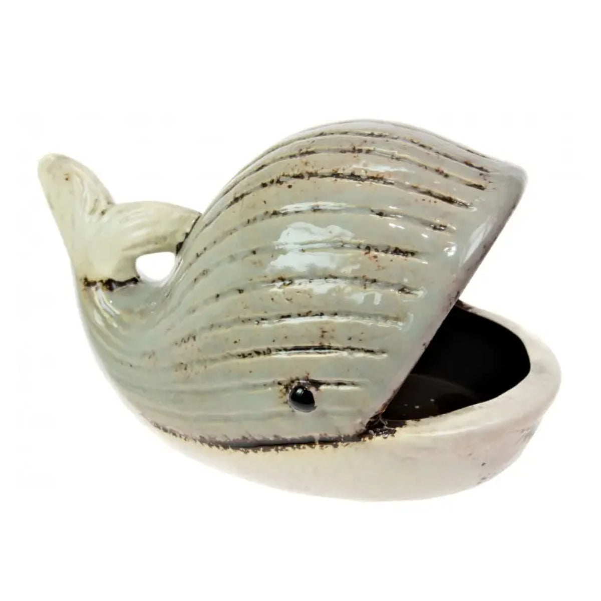 A ceramic whale-shaped container or dish with a glossy pale green-gray glaze, dark brown distressed lines, and a small black eye, shown on a plain white background.