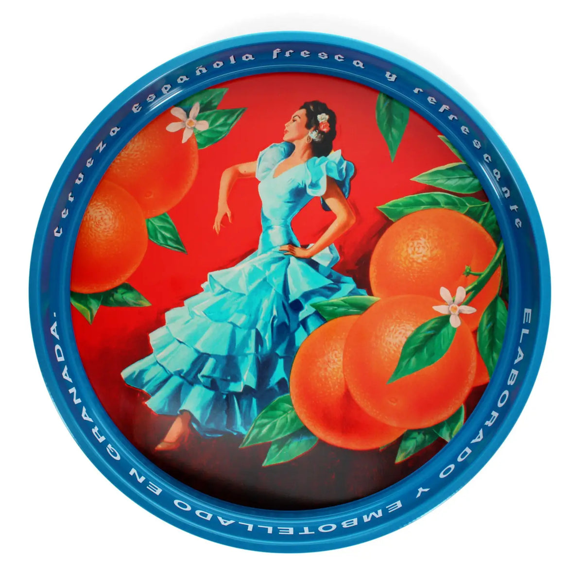 A round metal tin lid featuring a vibrant illustration of a woman in a light blue dress dancing among large oranges and green leaves on a red background, with a blue rim inscribed with Spanish text.