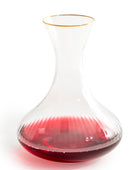 Wine decanter with red wine on a white background