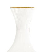 Clear glass carafe with gold rim on a white background
